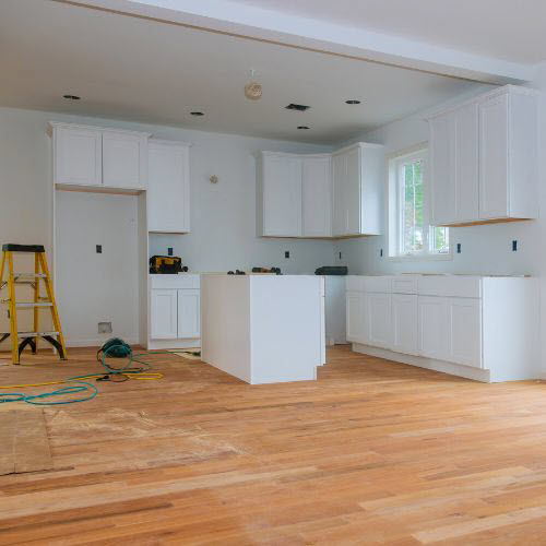 Renovated Kitchen With New Timber Floors And White Cabinets